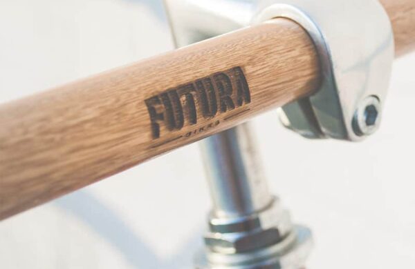 Close-up of a modern bicycle handlebar with wooden finish.