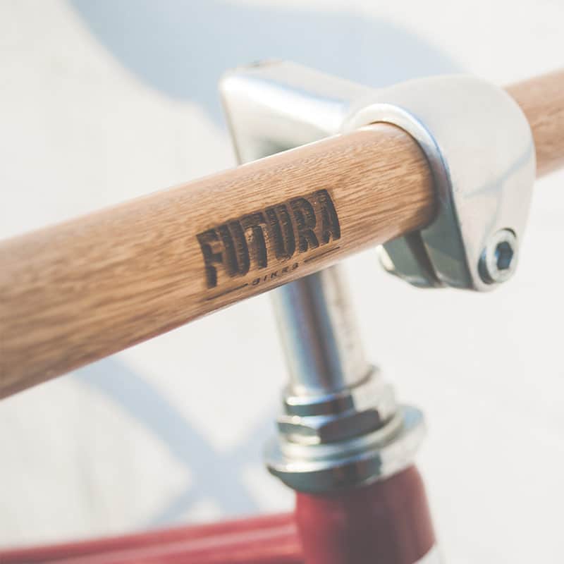 Close-up of a modern bicycle handlebar with wooden finish.