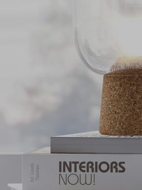 Modern home decor with a cork-based lamp on design books.