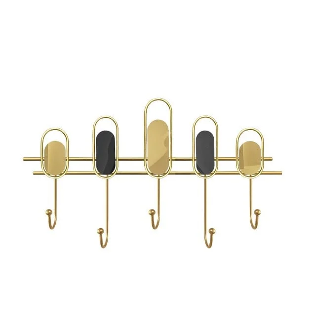 Modern gold wall hook with oval accents for luxury home decor.