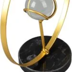 Modern gold and marble decorative sculpture with a spherical accent.