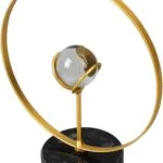 Modern gold and glass decorative sculpture with circular design on a black base.