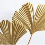 Gold decorative wall art with leaf design, modern luxury home decor.