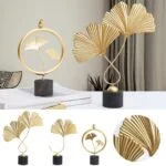 Elegant gold leaf sculptures on black bases for modern home decor.