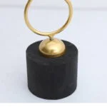 Gold decorative ornament on black base, modern home decor accessory.