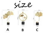 Gold decorative ornaments with black bases in various sizes.