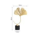Gold decorative sculpture with fan-shaped design on black base, modern home decor accessory.