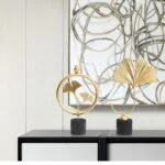 Modern luxury home decor with gold sculptures and abstract wall art.