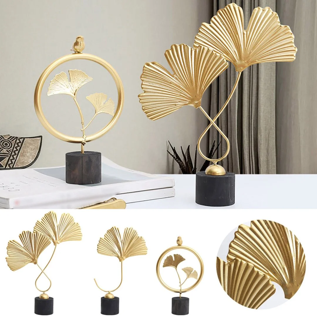Gold Leaf Sculptures for Modern Decor Elegant gold leaf sculptures on black bases for modern home decor.