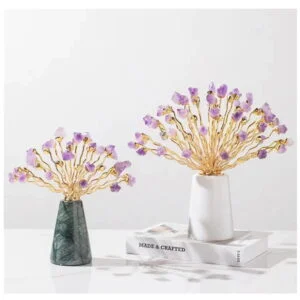 Elegant decorative ornaments with gold branches and purple accents on marble bases.