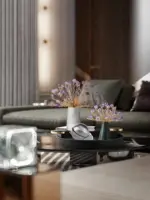 Modern living room with decorative vases and floral arrangements on a glass table.