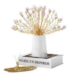 Elegant gold and crystal decorative ornament on a book, modern home decor accessory.