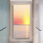 Modern framed wall art with sunset over ocean, enhancing luxury home decor.