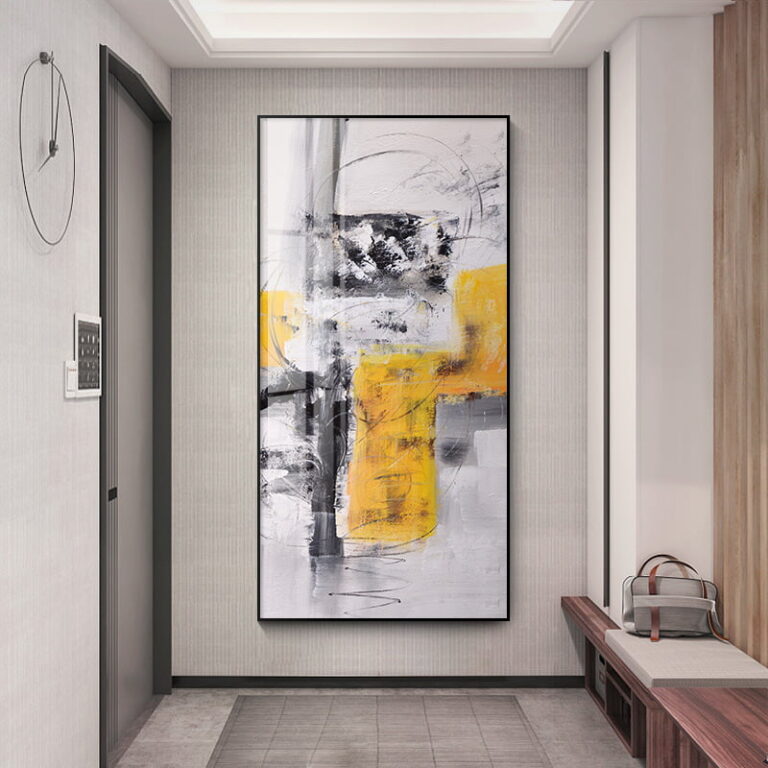 Modern abstract wall art with yellow and gray tones in a sleek hallway.