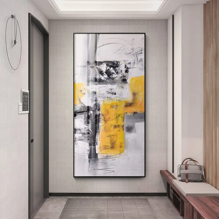 Modern abstract wall art with yellow and gray tones in a sleek hallway.