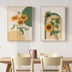 Modern framed wall art with sunflower designs above a dining table.