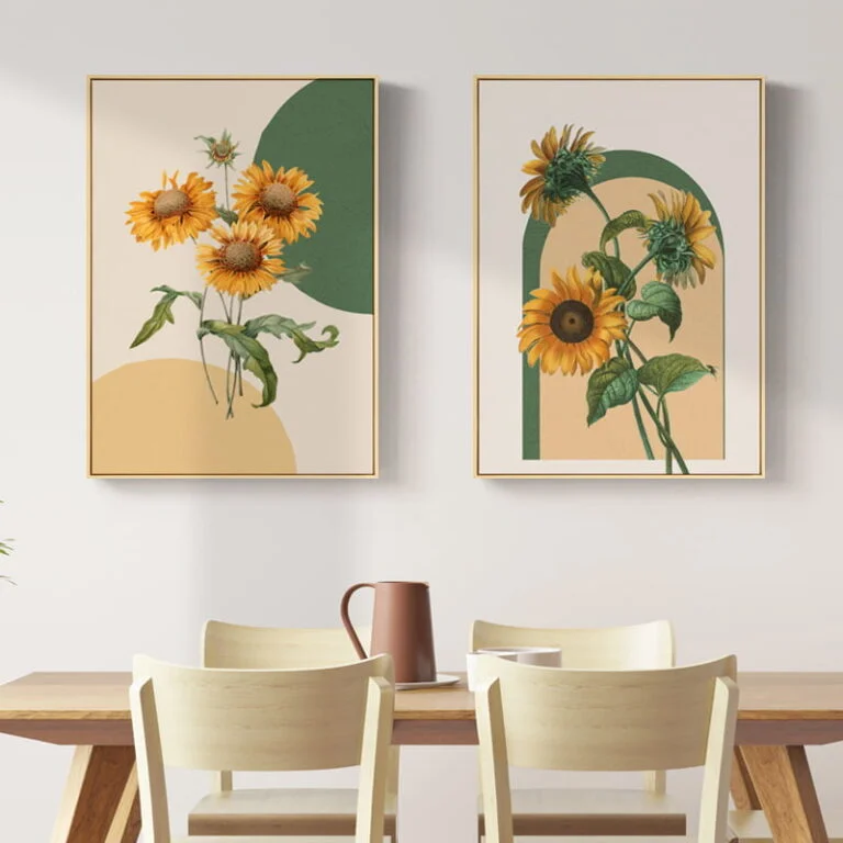 Modern framed wall art with sunflower designs above a dining table.