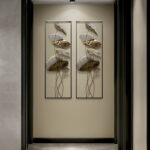 Modern luxury wall art with gold and silver leaf design in a hallway.