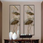Modern luxury wall art with gold leaf design and decorative vases in a stylish interior setting.
