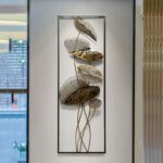 Modern metal wall art with leaf design in a luxury home setting.