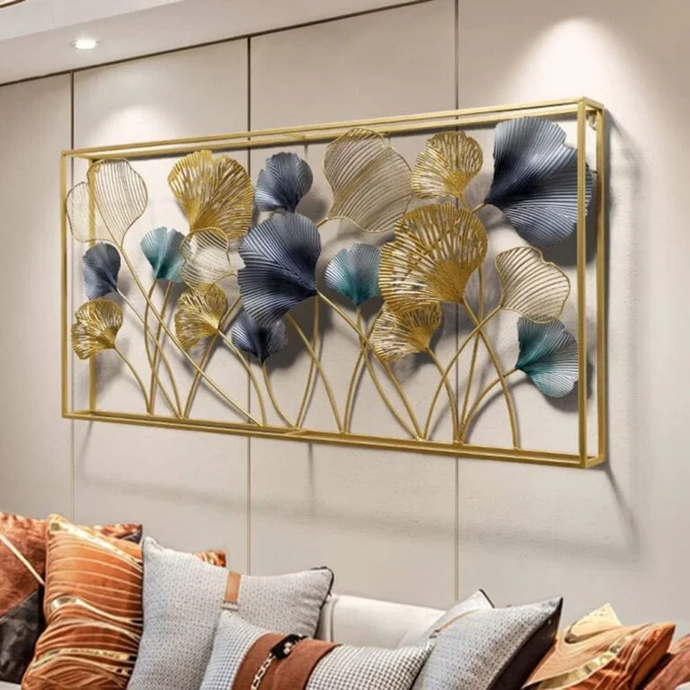Modern luxury wall art with gold and blue leaf design in a living room setting.