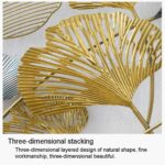 Gold metal wall art with three-dimensional leaf design for modern home decor.