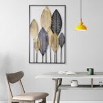 Modern metal wall art with leaf design in a minimalist dining room setting.