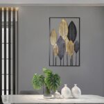 Modern luxury wall art with gold and black leaf design in a living room setting.