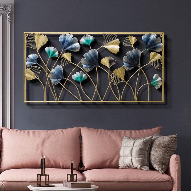 Modern luxury wall art with floral design in gold and blue above a pink sofa.