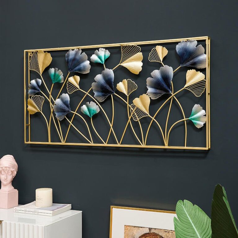 Modern gold and blue floral metal wall art in a living room setting.