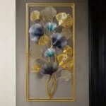 Modern gold and blue metal wall art with floral design in a rectangular frame.