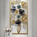 Modern gold and blue metal wall art with floral design in a hallway setting.