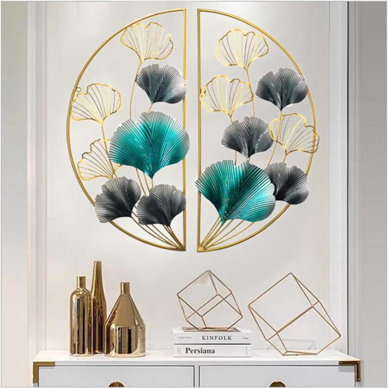 Modern gold and teal metal wall art with geometric decor on a white wall.