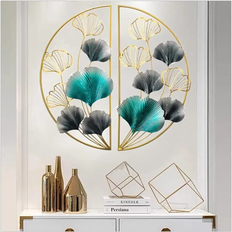 Modern gold and teal metal wall art with geometric decor on a white wall.