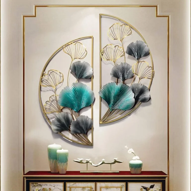Modern metal wall art with floral design in gold and teal, above a decorative console with vases.