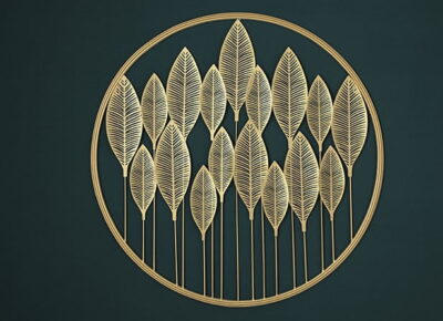 Gold metal wall art with leaf design in a circular frame, modern home decor accent.