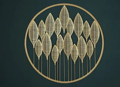 Gold metal wall art with leaf design in a circular frame, modern home decor accent.