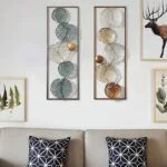 Modern metal wall art with geometric patterns above a sofa in a stylish living room.