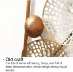 Modern decorative wall art with metal accents and intricate design.