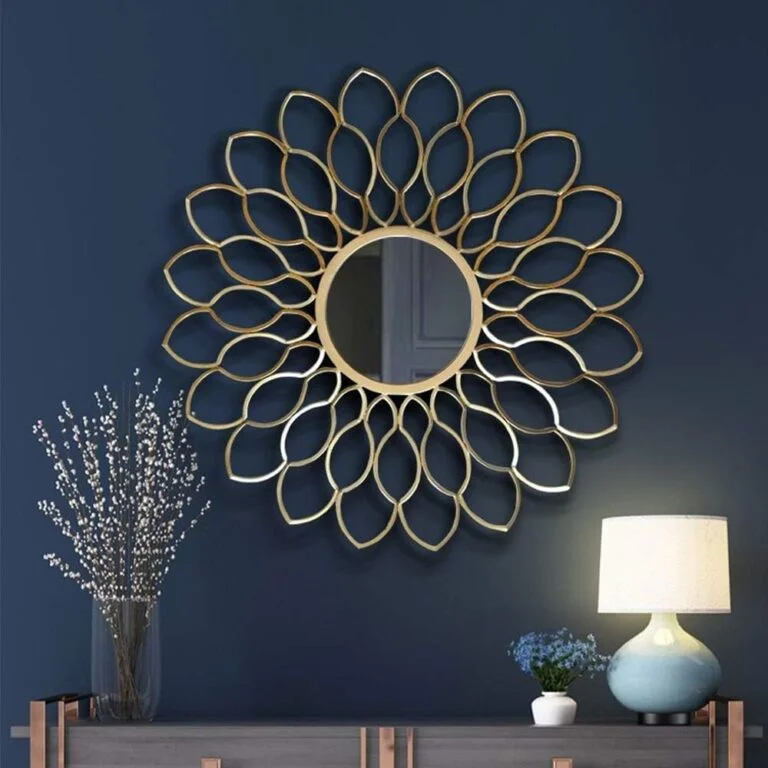 Elegant gold decorative wall mirror in a modern living room setting.