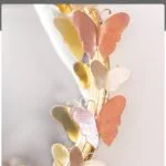 Decorative mirror with butterfly accents in modern luxury home decor style.