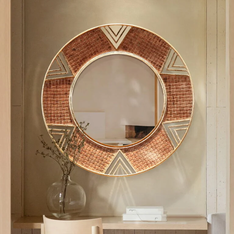 Modern decorative round wall mirror with geometric patterns in a luxury home setting.