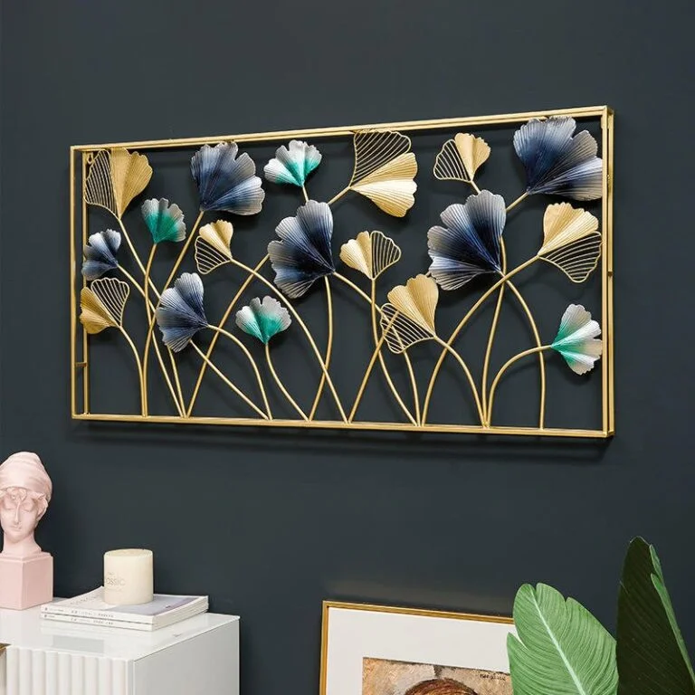Modern gold and blue floral metal wall art in a living room setting.