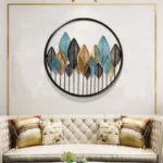 Modern luxury wall art with metal leaves in a living room setting.