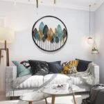 Modern living room with circular metal wall art and elegant decor.