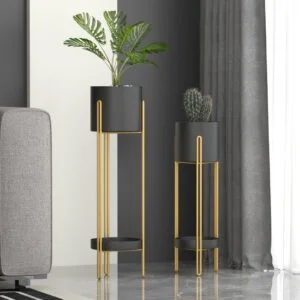 Modern gold and black indoor planters with plants in a stylish living room setting.