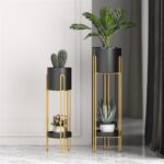 Modern gold and black indoor planters with plants for luxury home decor.