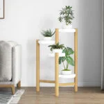 Modern wooden plant stand with white pots in a stylish living room.