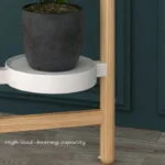Modern indoor planter with wooden stand and black pot, suitable for home decor.