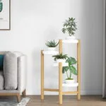 Modern indoor planter with wooden frame and white pots in a stylish living room.